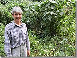 Karen standing near a group of gorillas in the Bwindi Impenetrable Forest